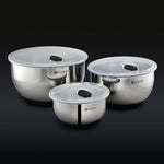 3 HexClad stainless steel mixing bowls with vacuum seal lids on a black background.